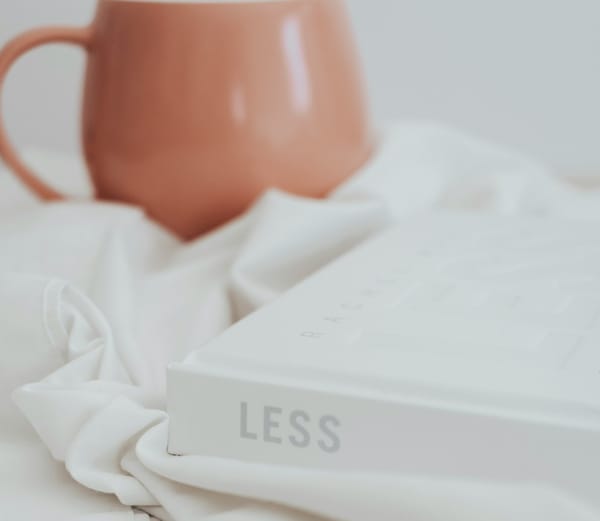 a white book with the title less